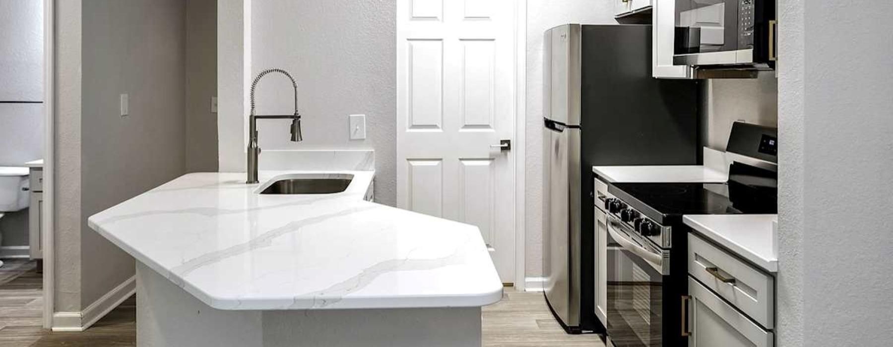 a kitchen with a sink and a refrigerator